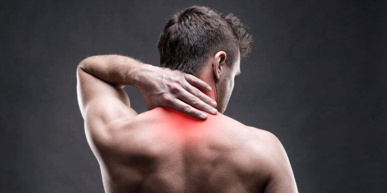 Man holding the back of his neck where occipital nerve pain can start