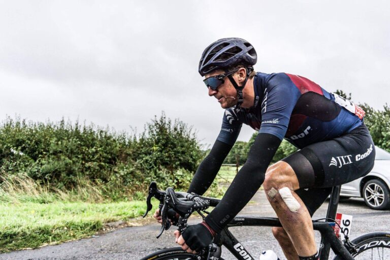 Cyclist riding with a bandaged knee after a sports injury