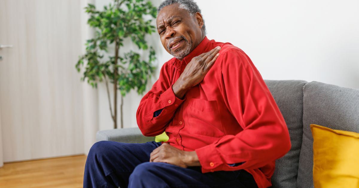 Older man experiencing shoulder pain at home